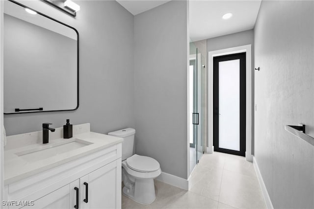 bathroom featuring tile patterned flooring, vanity, and toilet