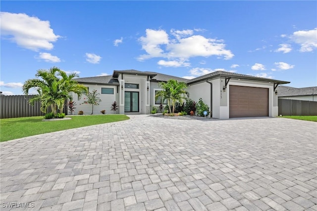 view of front of property with a garage and a front lawn