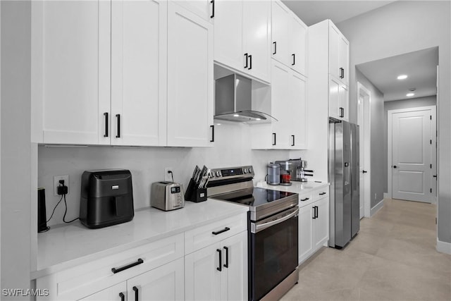 kitchen with light stone countertops, stainless steel appliances, white cabinetry, and exhaust hood