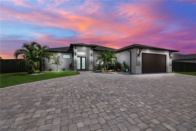 view of front of house with a lawn and a garage