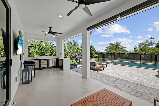 view of patio with a fenced in pool and ceiling fan