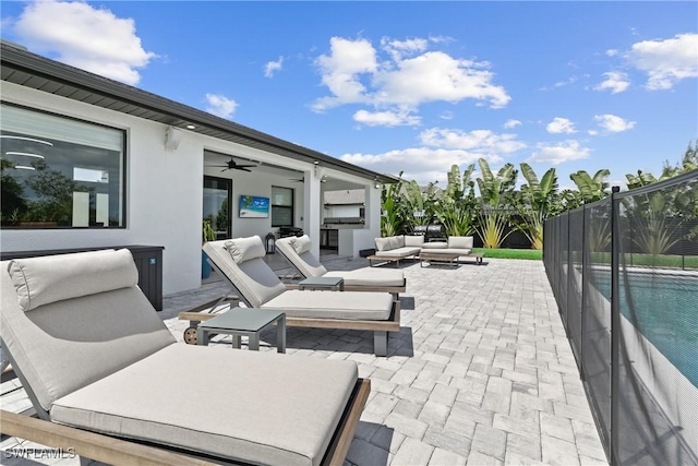 view of patio / terrace with ceiling fan, a fenced in pool, and an outdoor living space