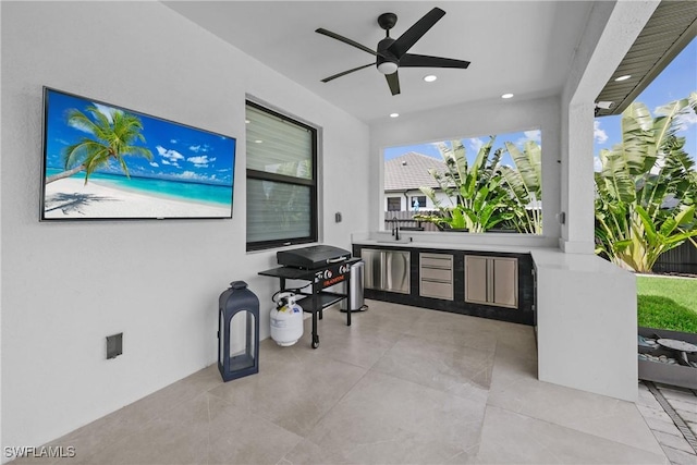 view of patio / terrace featuring ceiling fan, exterior kitchen, and sink