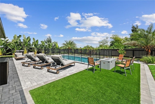 view of pool featuring a lawn and a patio