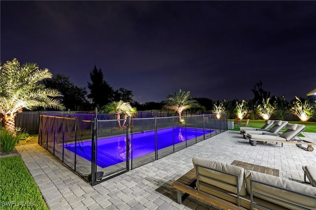 pool at twilight featuring a patio