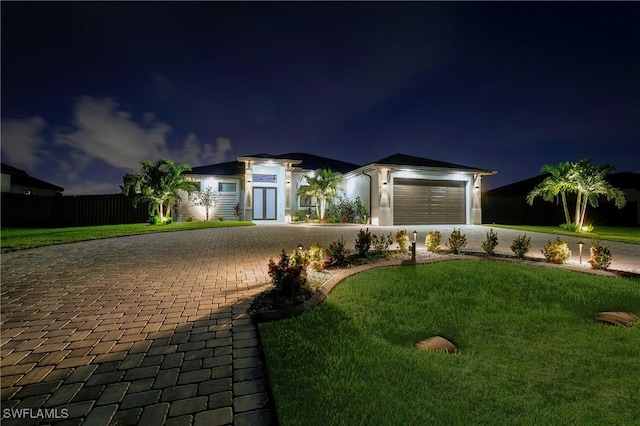 view of front of house with a lawn and a garage