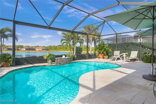 view of pool with pool water feature, a water view, glass enclosure, and a patio area