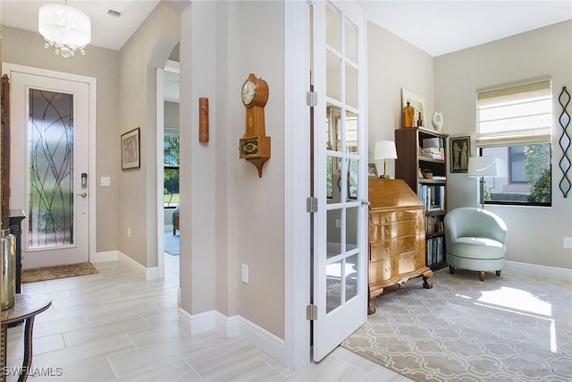 entryway featuring an inviting chandelier