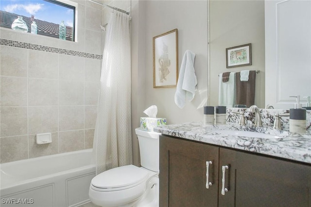 full bathroom with vanity, shower / tub combo, and toilet