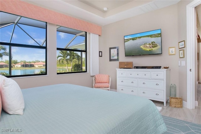 bedroom featuring a water view and light wood-type flooring