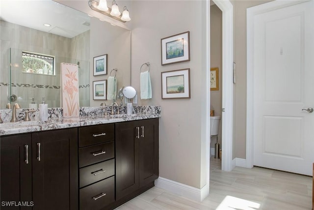 bathroom with a shower, vanity, and toilet