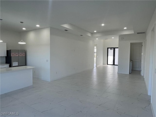 spare room with a tray ceiling