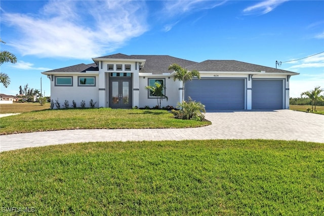 view of front of house with a garage and a front yard