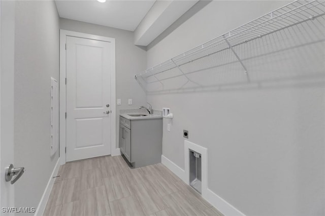 laundry room with electric dryer hookup, hookup for a washing machine, cabinets, and sink