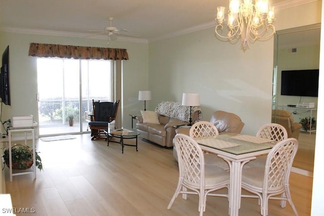 dining area with ceiling fan with notable chandelier, light hardwood / wood-style flooring, and crown molding