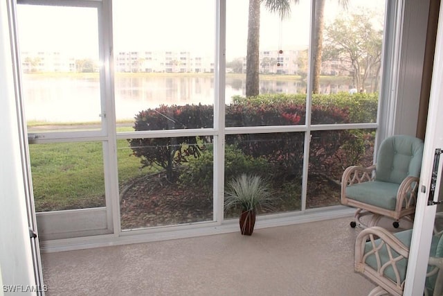 sunroom with a water view and a wealth of natural light