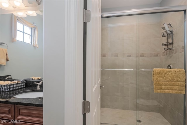 bathroom with vanity and a shower with door