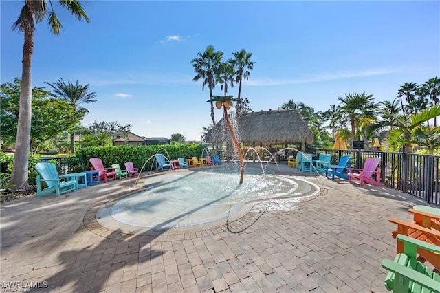 exterior space featuring pool water feature and a patio area