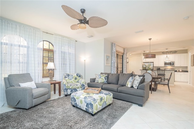 living room with ceiling fan and light tile patterned floors