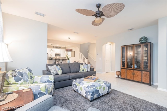 tiled living room with ceiling fan