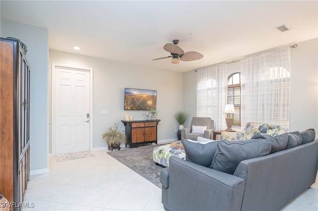 living room with ceiling fan and light tile patterned flooring