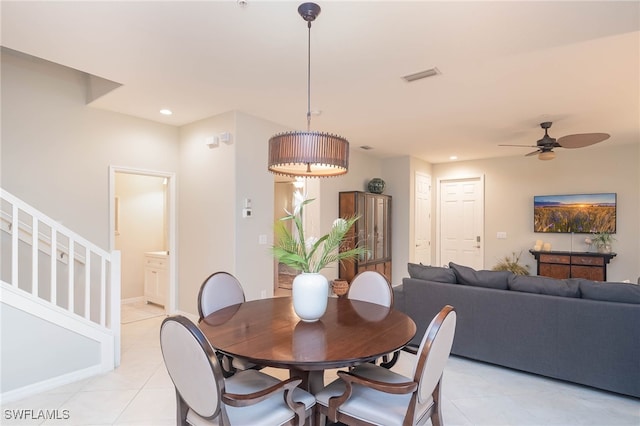 dining space featuring light tile patterned floors and ceiling fan