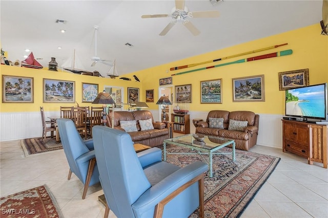 tiled living room featuring ceiling fan and lofted ceiling