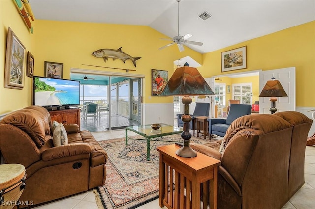 living room featuring ceiling fan, light tile patterned floors, and lofted ceiling