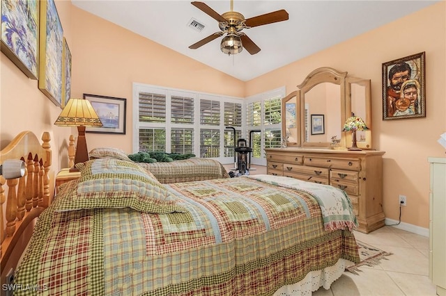 bedroom with ceiling fan, light tile patterned floors, and vaulted ceiling