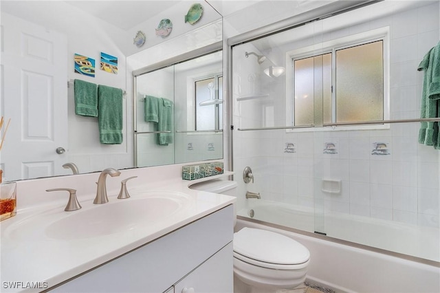 full bathroom featuring vanity, toilet, and bath / shower combo with glass door