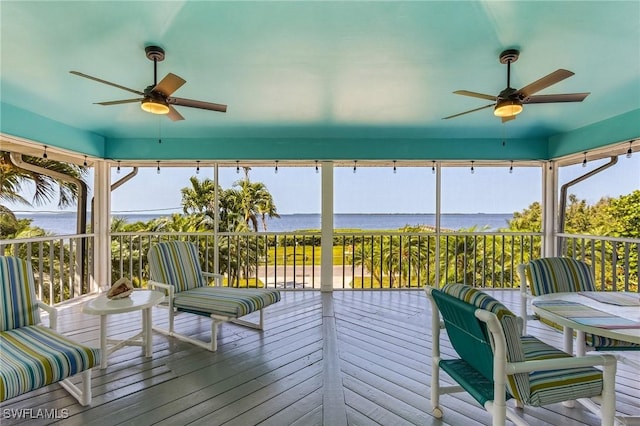 sunroom featuring a water view and a wealth of natural light