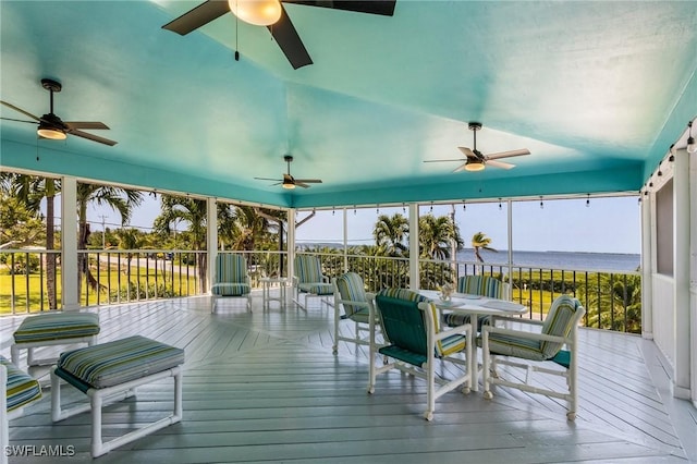 sunroom featuring a water view and a healthy amount of sunlight