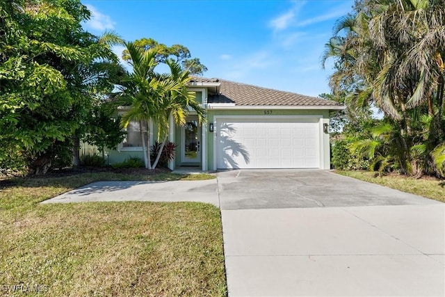 view of front of house featuring a garage and a front lawn