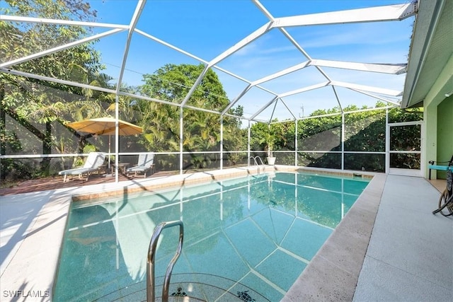 view of swimming pool with glass enclosure and a patio area