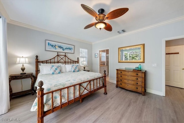 bedroom with ceiling fan, light hardwood / wood-style floors, ornamental molding, and connected bathroom