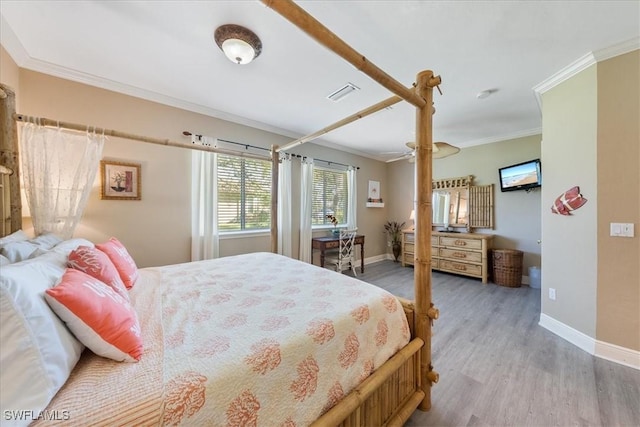 bedroom featuring light hardwood / wood-style floors and crown molding