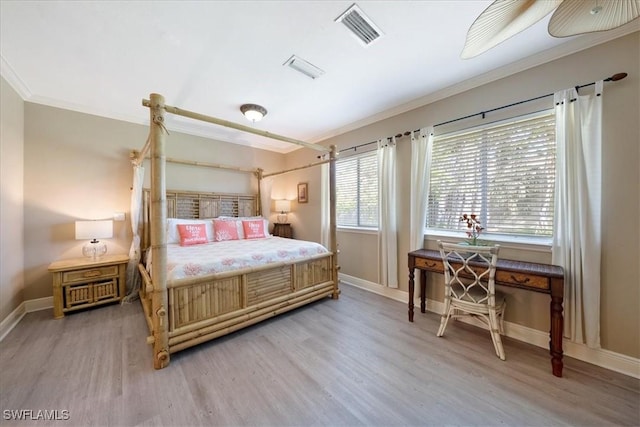 bedroom with hardwood / wood-style floors and crown molding