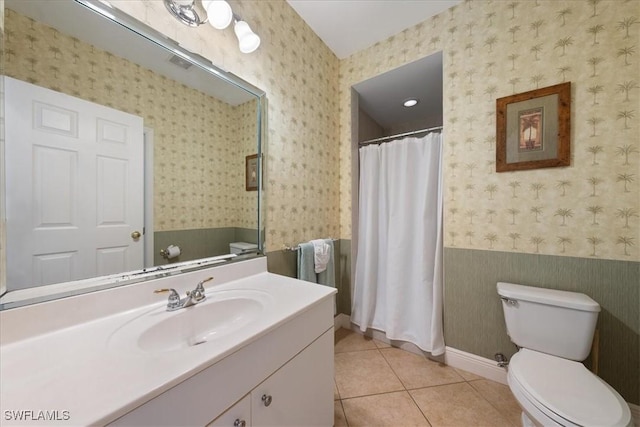 bathroom featuring tile patterned floors, vanity, and toilet