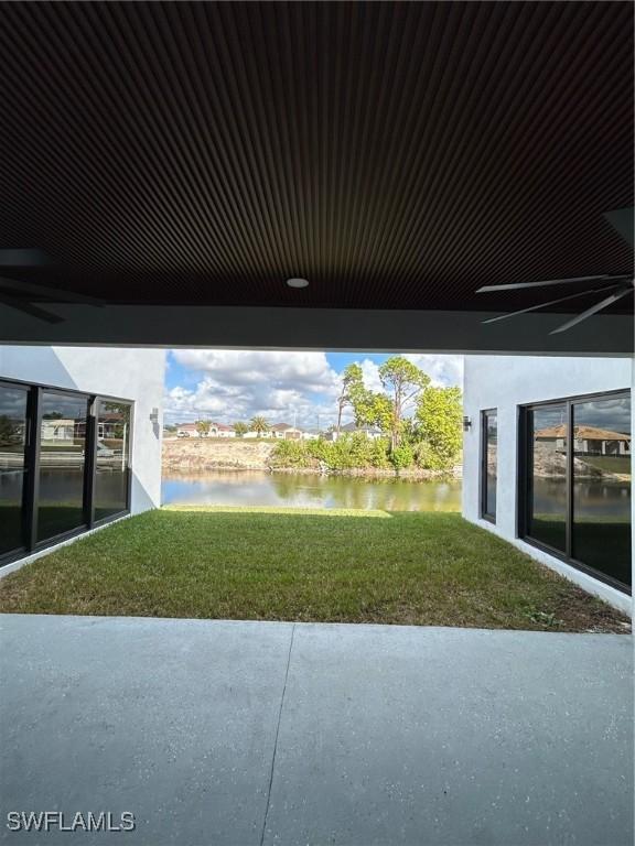 view of yard featuring a patio area and a water view