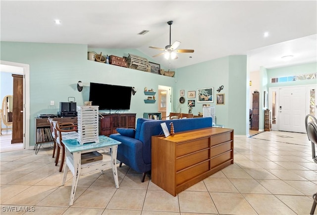 tiled living room with ceiling fan and vaulted ceiling