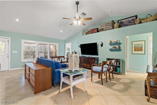 tiled living room with ceiling fan and high vaulted ceiling