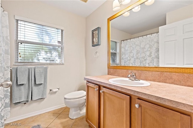 bathroom with tile patterned floors, vanity, and toilet