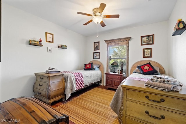 bedroom featuring wood-type flooring and ceiling fan