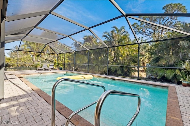 view of swimming pool featuring a lanai and a patio