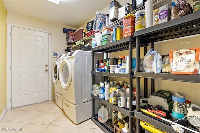 washroom featuring washer and dryer and light tile patterned flooring