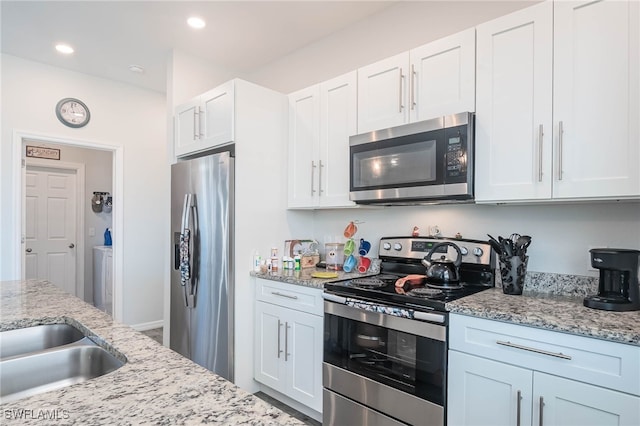 kitchen with white cabinetry, light stone countertops, and appliances with stainless steel finishes