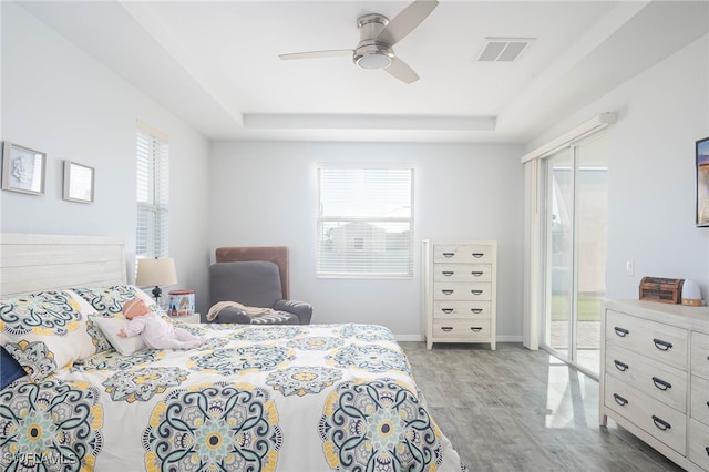 bedroom featuring a tray ceiling and ceiling fan