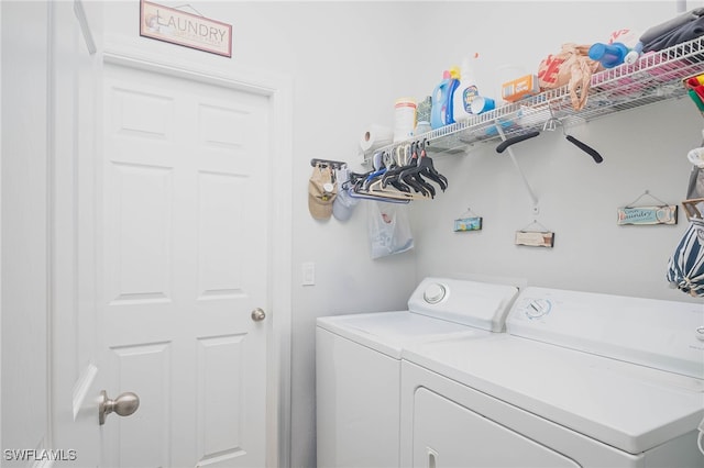 clothes washing area featuring separate washer and dryer