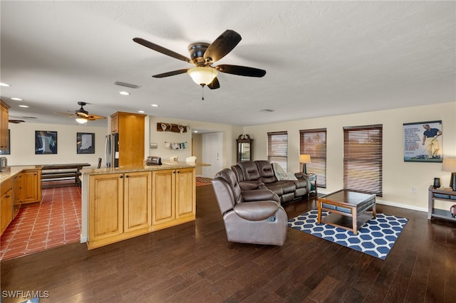 living area with a textured ceiling, dark wood finished floors, visible vents, and recessed lighting