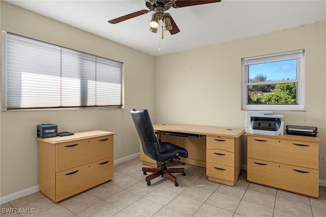 office space featuring light tile patterned flooring, ceiling fan, and baseboards